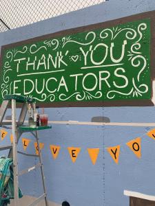 Side angle of mural progress. 'Thank you educators&quot;