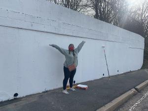 Anna Dugan with blank canvas wall