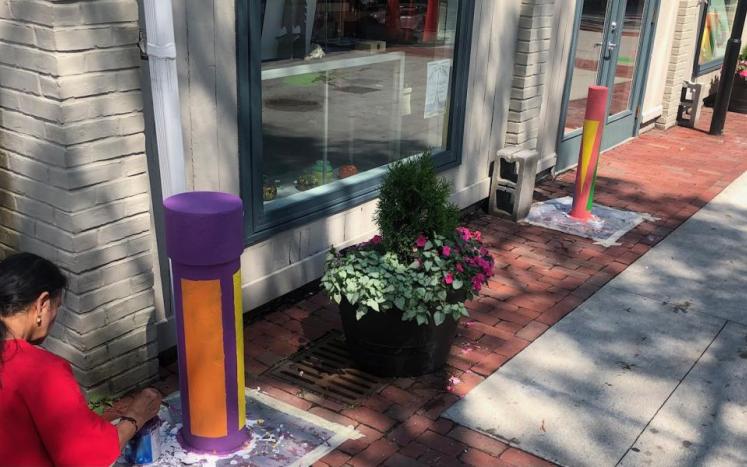 Salem artist Indra Persad-Milowe paints “Healing colors” on bollards along Artists’ Row for her PAC Mini Grant funded project